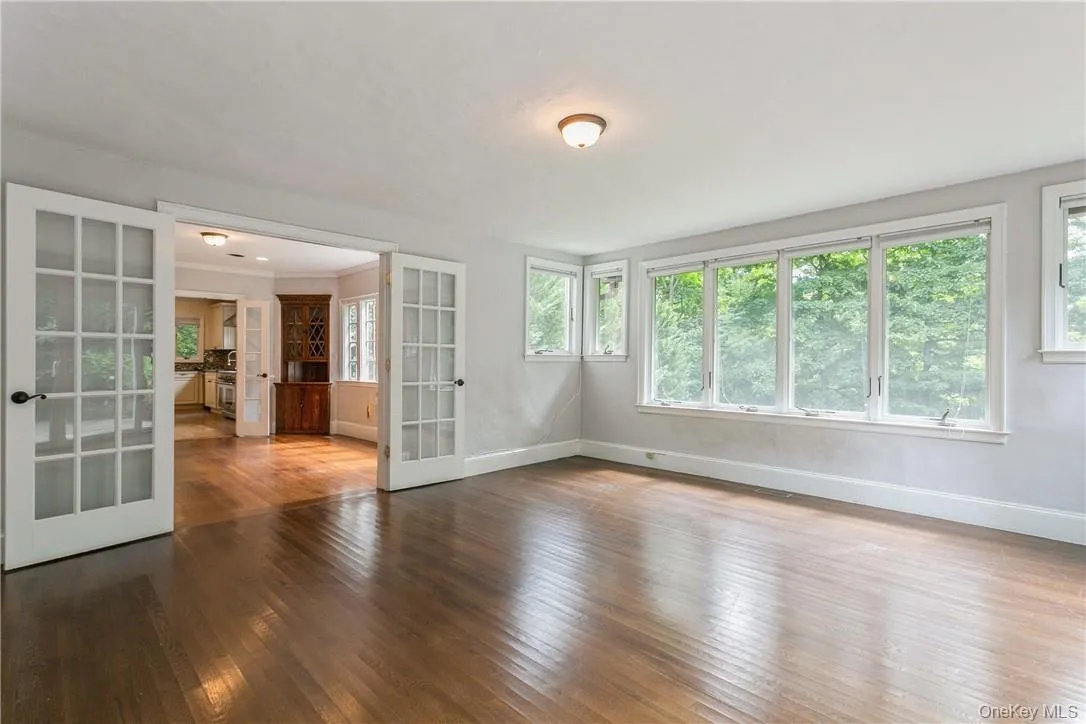 Family room with endless windows and sliders to a patio. Family room with endless windows and sliders to a patio.