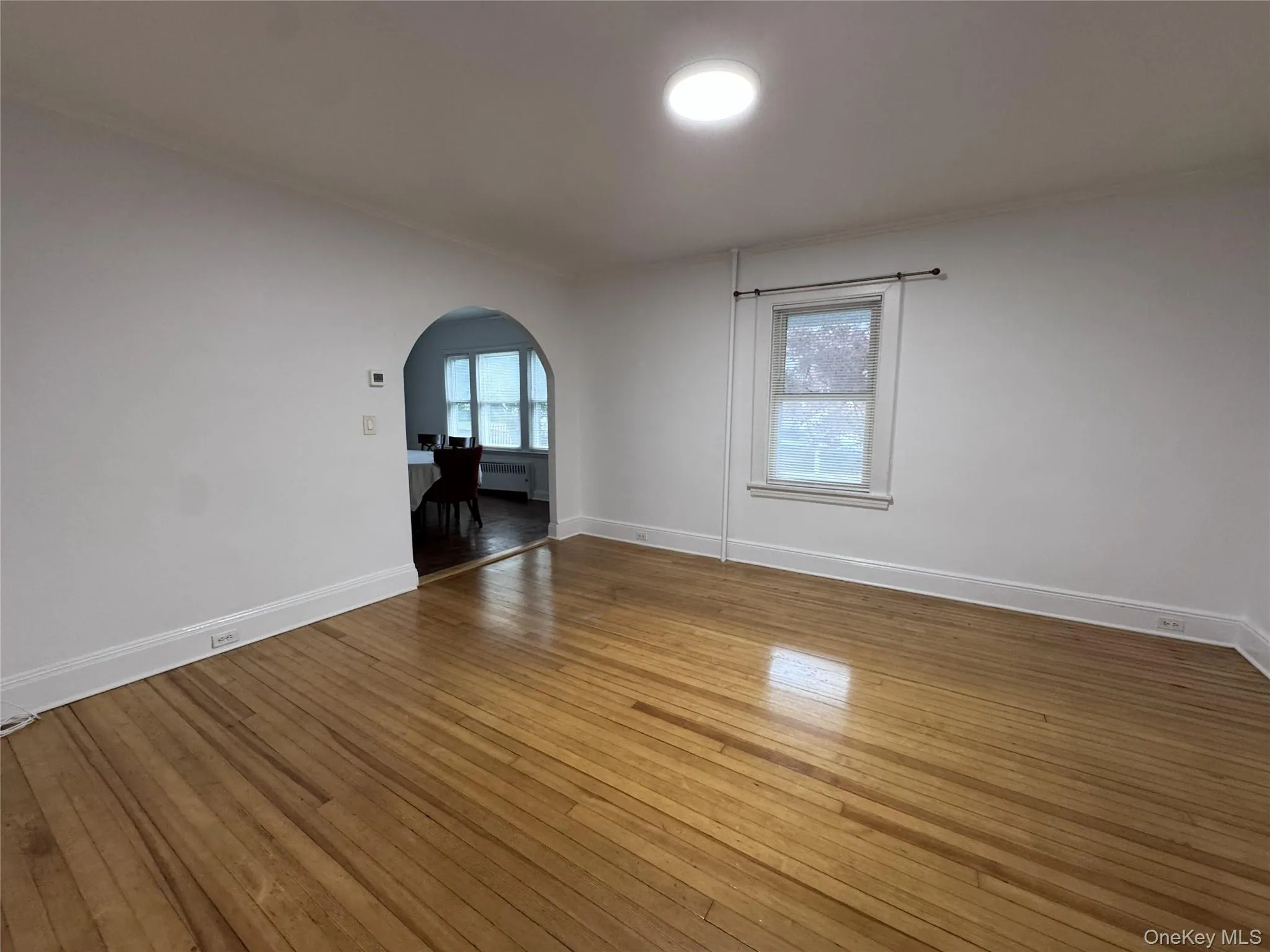 Bright living room leading into dining room Bright living room leading into dining room