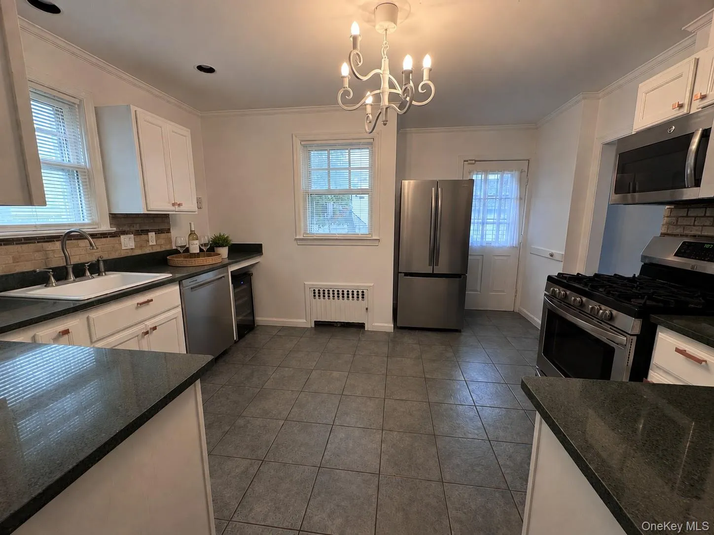 Updated spacious kitchen with access to back deck Updated spacious kitchen with access to back deck