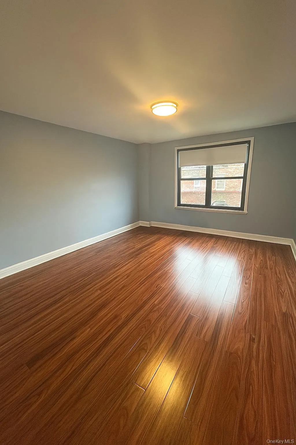 Primary Bedroom featuring baseboards and dark wood-type flooring Primary Bedroom featuring baseboards and dark wood-type flooring