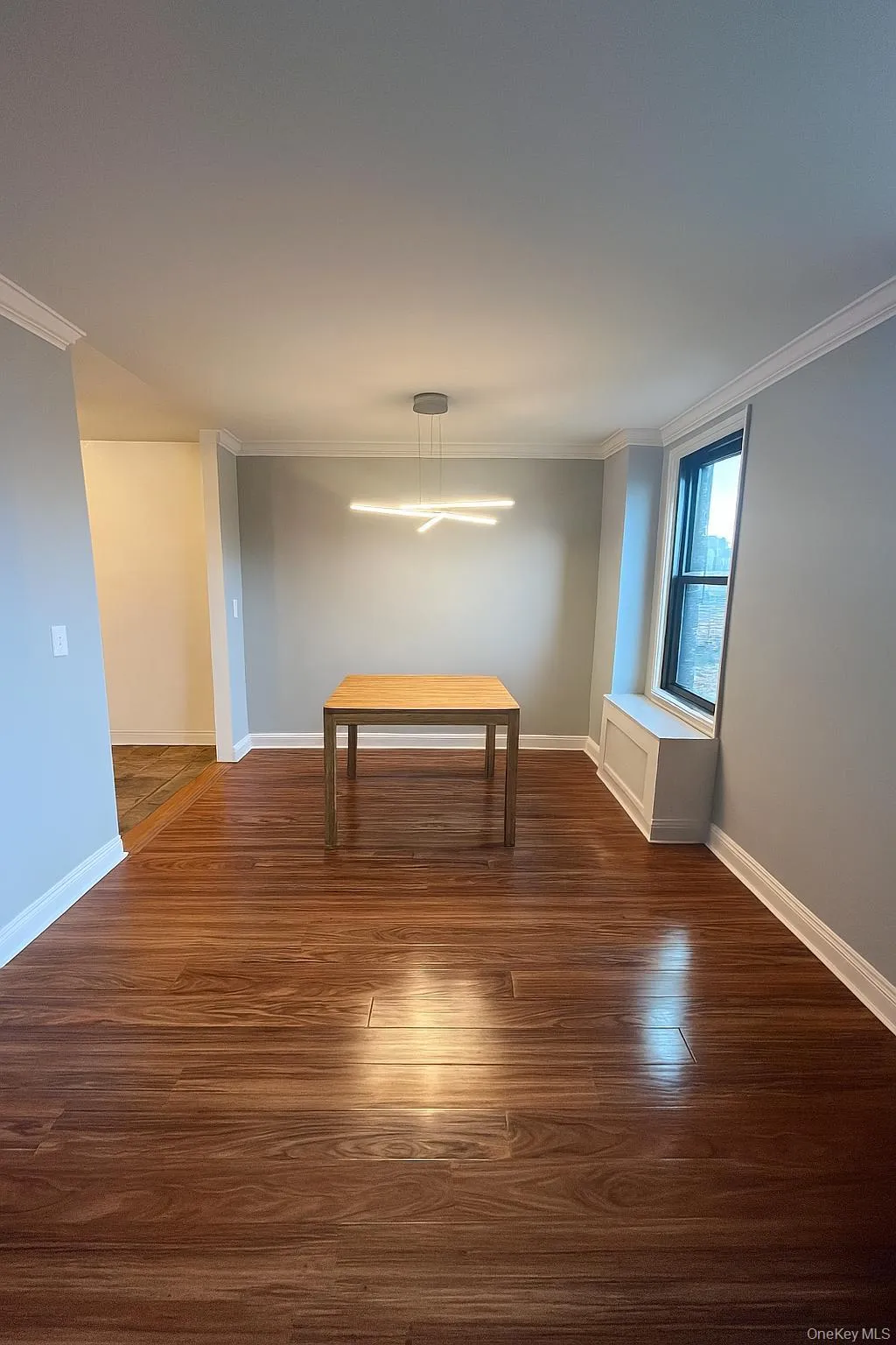 Dining area featuring ornamental molding and dark wood-type flooring Dining area featuring ornamental molding and dark wood-type flooring