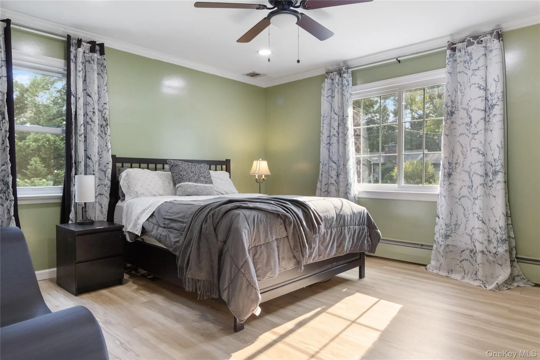Get cozy in this modern primary bedroom suite. It features lots of natural light, an open walk-in closet, and a secret entry into the living room. Get cozy in this modern primary bedroom suite. It features lots of natural light, an open walk-in closet, and a secret entry into the living room.