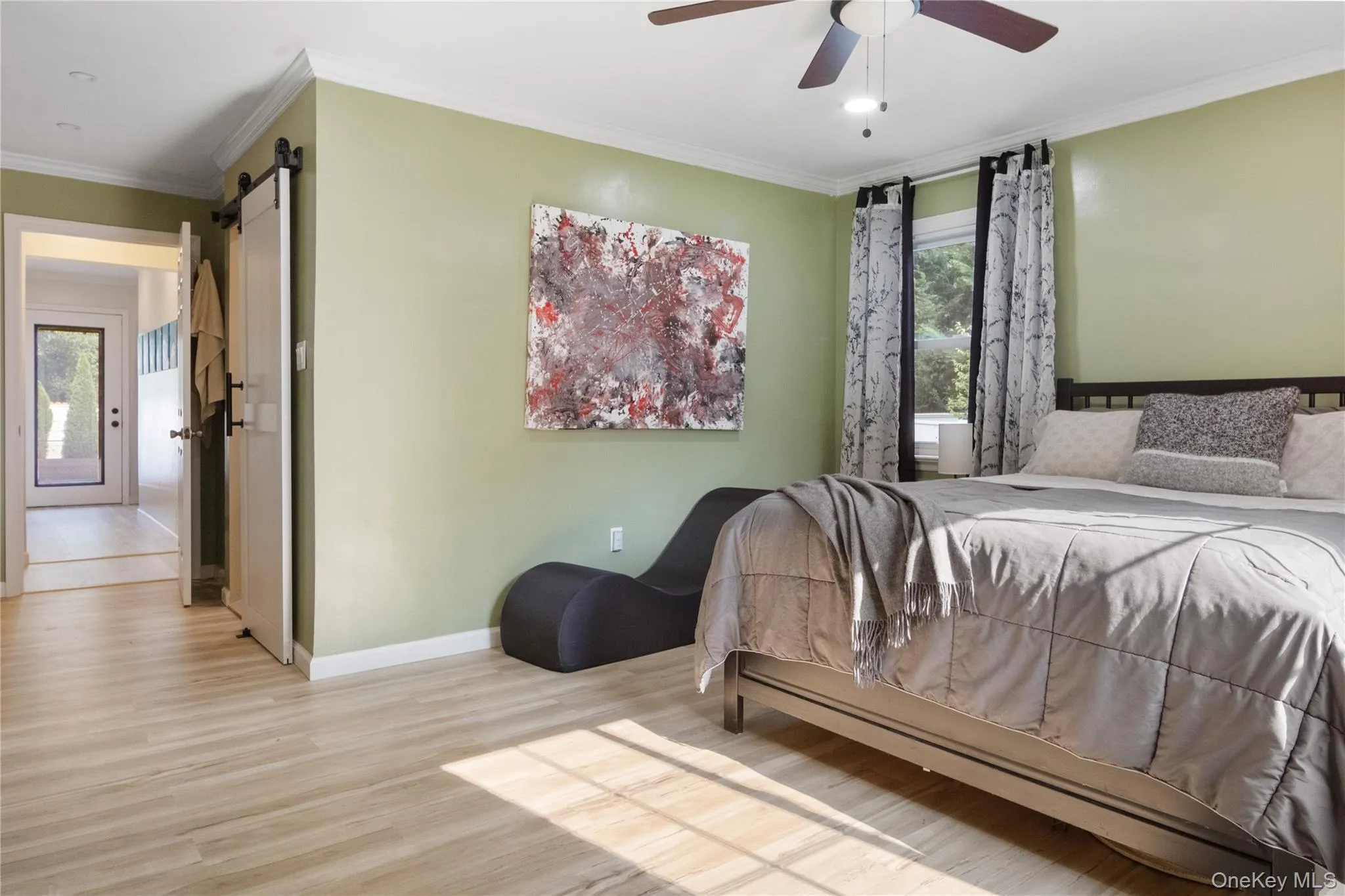 The primary bedroom opens to a contemporary primary bath and hallway. The primary bedroom opens to a contemporary primary bath and hallway.