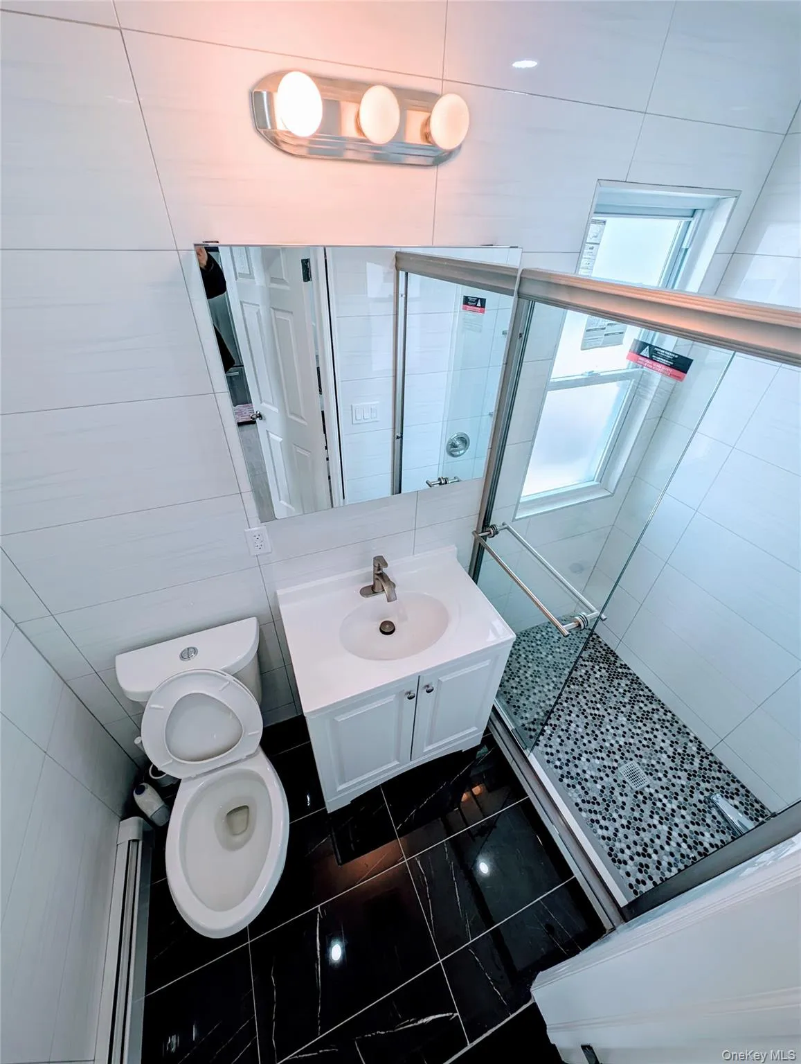 Full bathroom featuring toilet, a shower stall, and vanity Full bathroom featuring toilet, a shower stall, and vanity