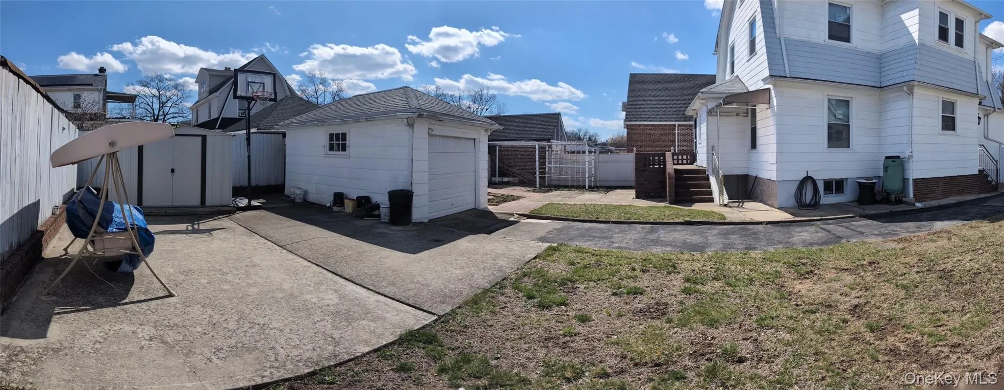 View of home's exterior featuring fence, an outdoor structure, a garage, and a storage unit View of home's exterior featuring fence, an outdoor structure, a garage, and a storage unit
