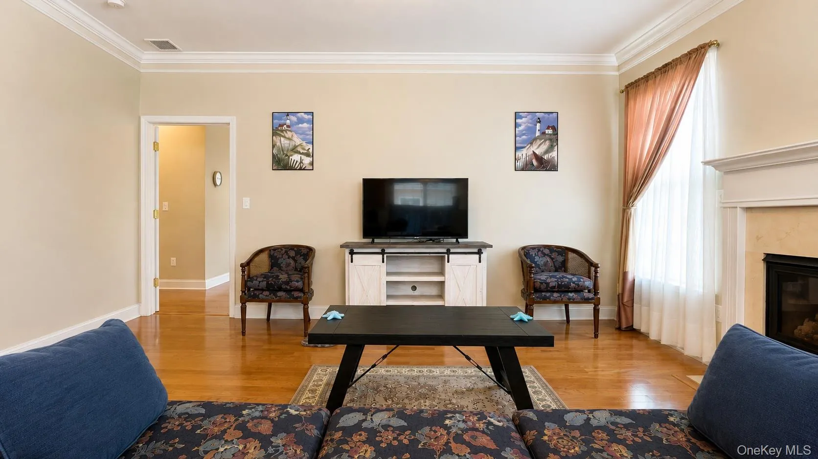 Hardwood-finish flooring, crown molding, fireplace with mantel, and recessed lighting Hardwood-finish flooring, crown molding, fireplace with mantel, and recessed lighting