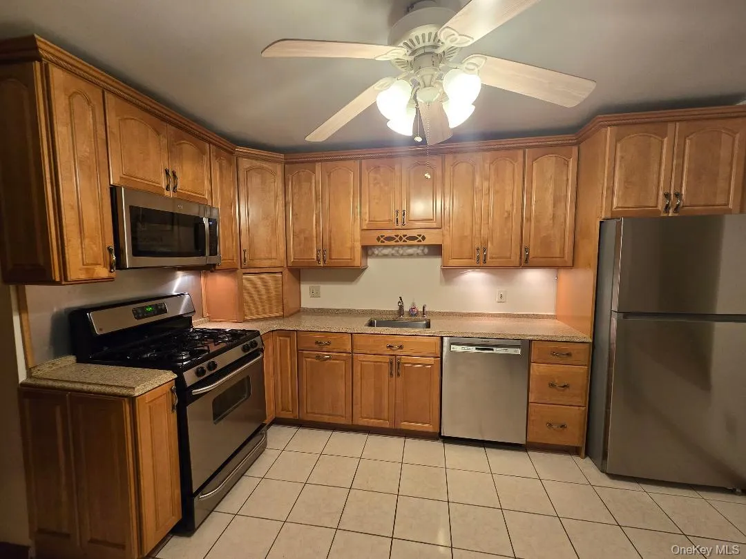 Huge, Eat-in-kitchen, featuring ceramic tiled flooring, Lots of solid wood Cabinetry, Stainless Steel Applicance (Gas Stove, DW, Brand New Fridge), Granite Coutertops & Large Window! Huge, Eat-in-kitchen, featuring ceramic tiled flooring, Lots of solid wood Cabinetry, Stainless Steel Applicance (Gas Stove, DW, Brand New Fridge), Granite Coutertops & Large Window!