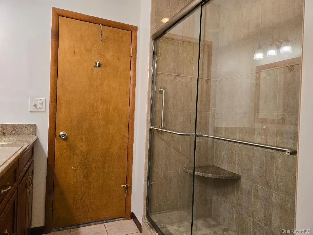 This shower is completely tiled with luxurious tiles! There is a seat as well. This shower is completely tiled with luxurious tiles! There is a seat as well.