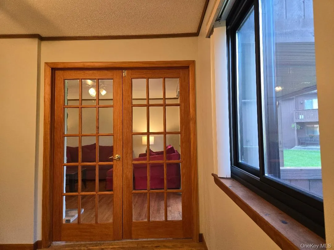 View of the Large Window and beautiful French Doors leading from the Dining Room the Living Room and Patio Doors. View of the Large Window and beautiful French Doors leading from the Dining Room the Living Room and Patio Doors.