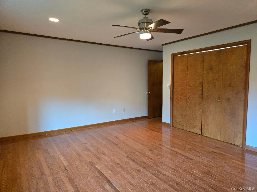Nice view of the extra large Primary Suite! Featuring Hardwood flooring, recessed lighting, ceiline fan w/remote, and extra large closet. Nice view of the extra large Primary Suite! Featuring Hardwood flooring, recessed lighting, ceiline fan w/remote, and extra large closet.