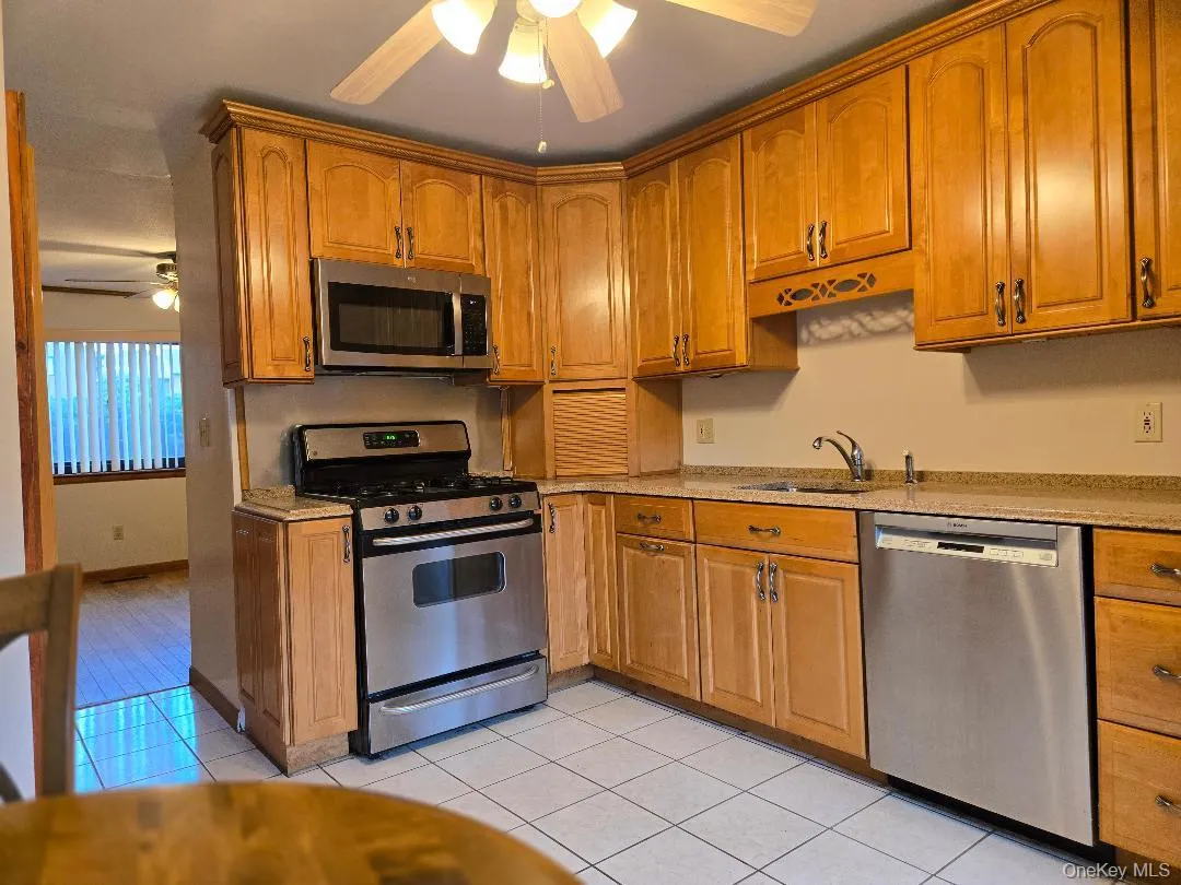 Huge, Eat-in-kitchen, featuring ceramic tiled flooring, Lots of solid wood Cabinetry, Stainless Steel Applicance (Gas Stove, DW, Fridge), Granite Coutertops & Large Window! Huge, Eat-in-kitchen, featuring ceramic tiled flooring, Lots of solid wood Cabinetry, Stainless Steel Applicance (Gas Stove, DW, Fridge), Granite Coutertops & Large Window!