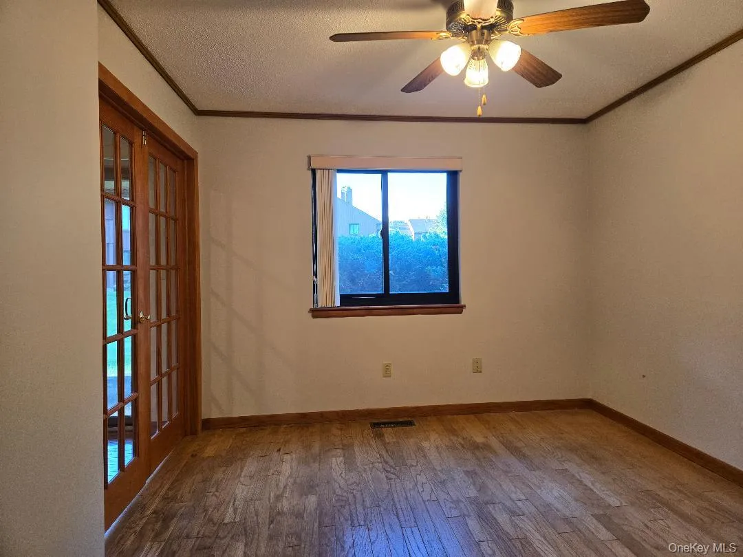 Another view of the very large Dining Room, featuring hardwood flooring & ceiling fan. Another view of the very large Dining Room, featuring hardwood flooring & ceiling fan.