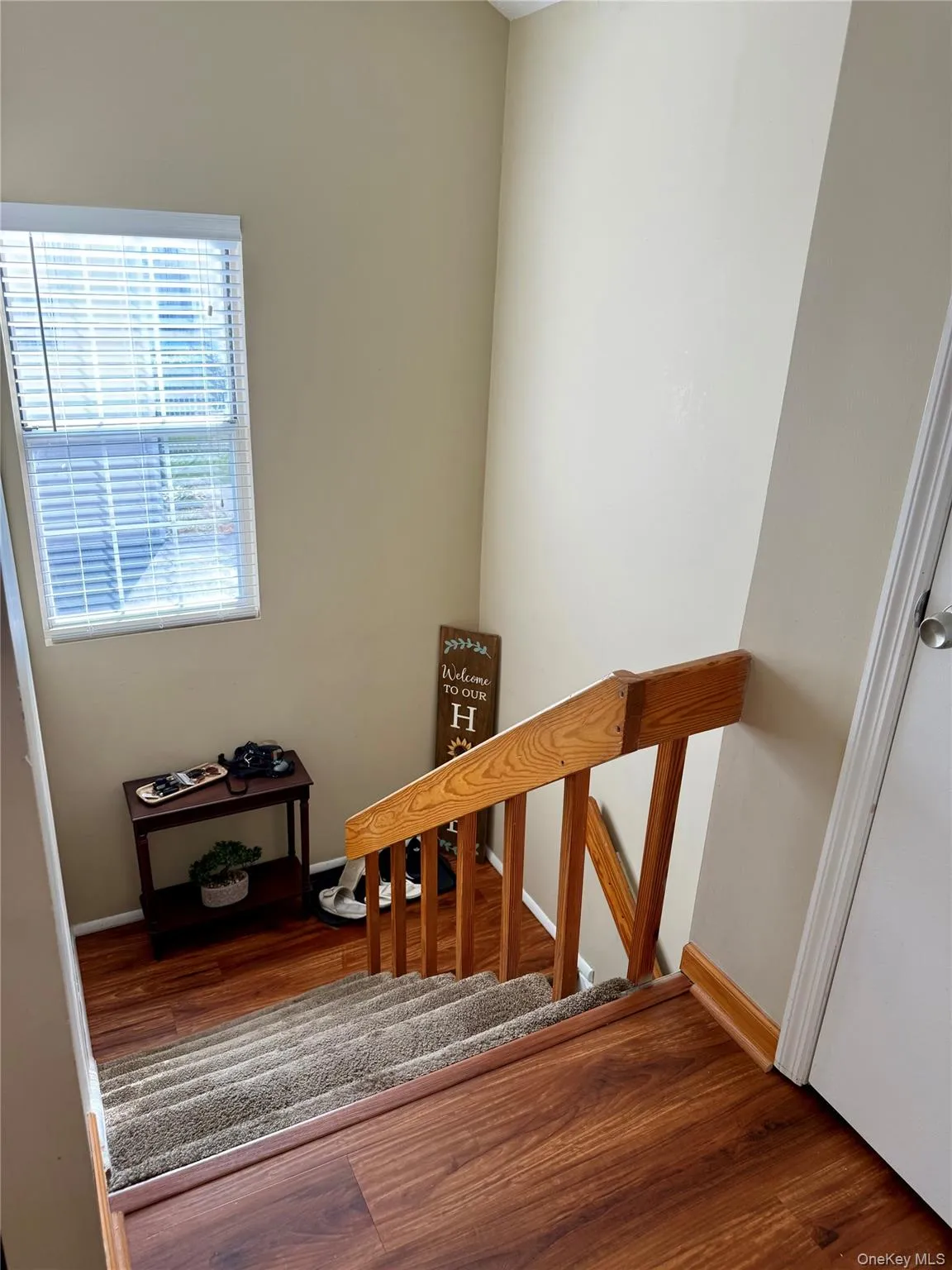 Stairway featuring wood finished floors and baseboards Stairway featuring wood finished floors and baseboards