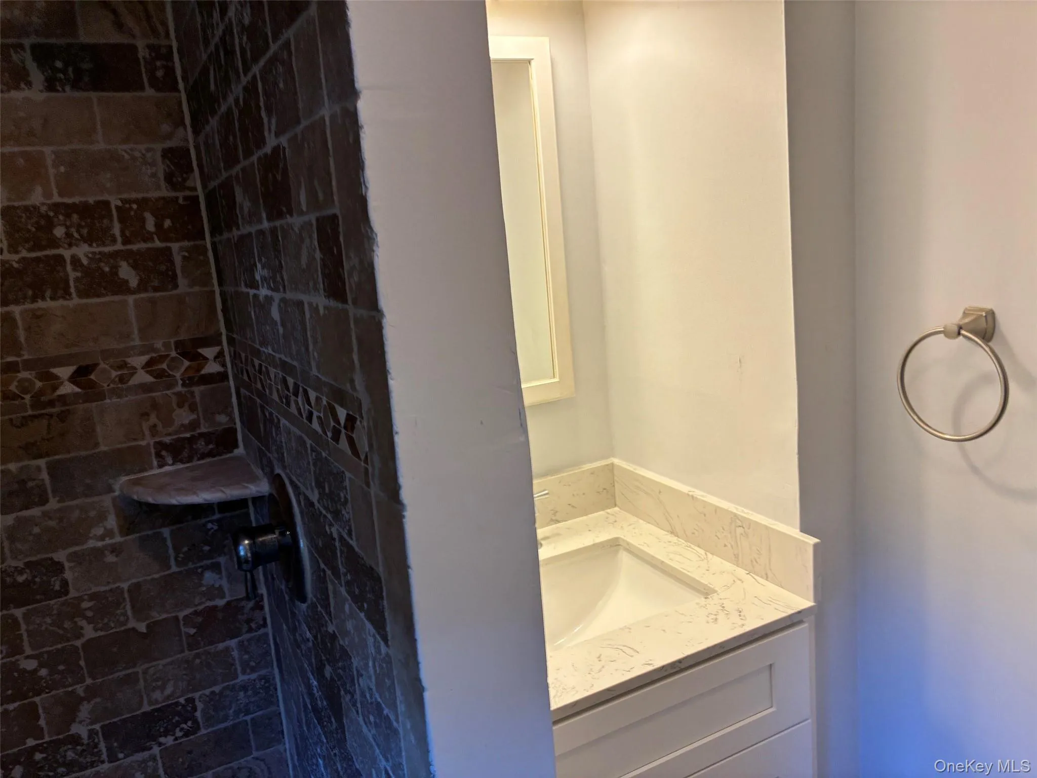 Full bathroom with tiled stall shower, sink with vanity Full bathroom with tiled stall shower, sink with vanity