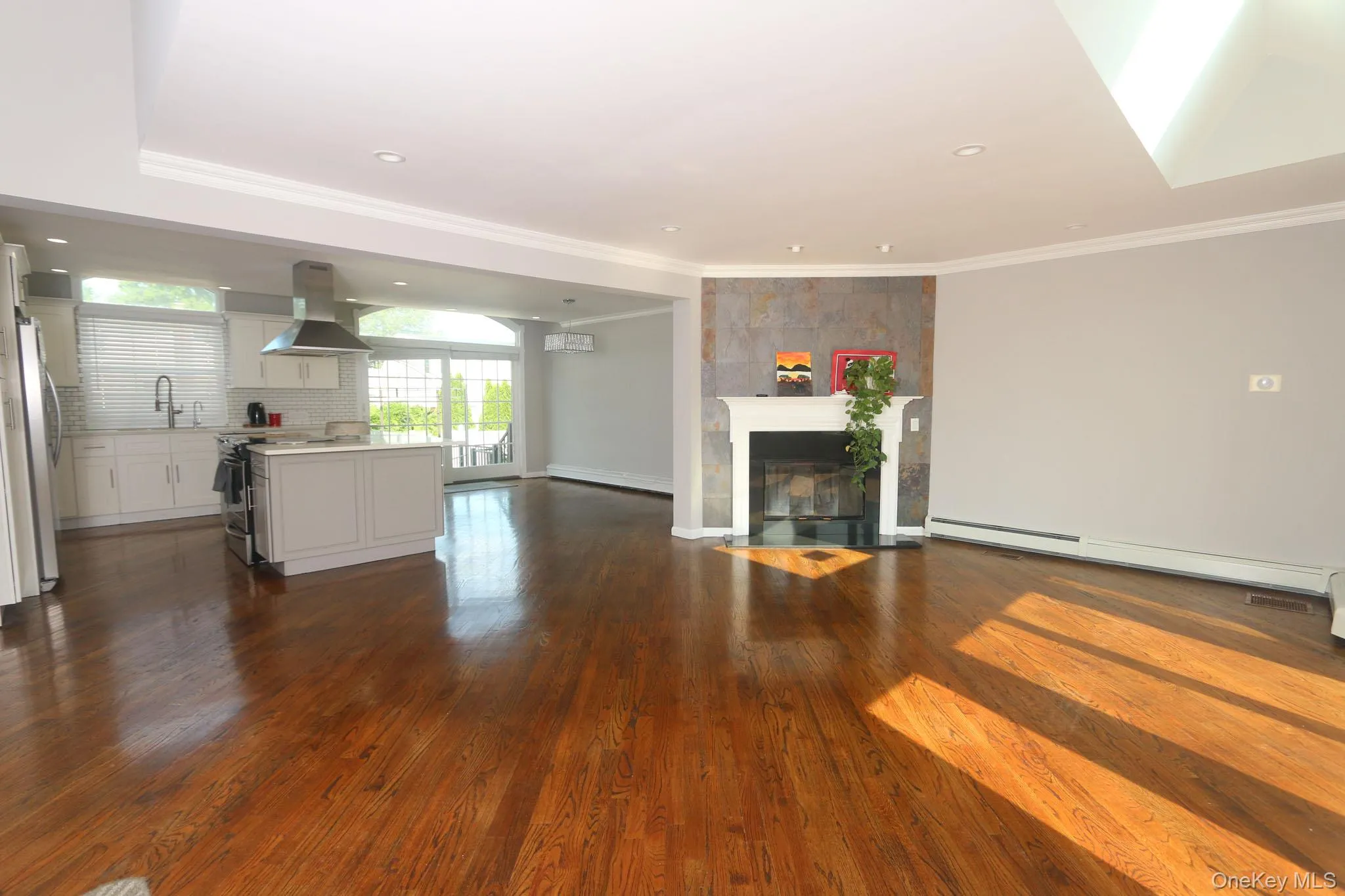 Open-concept living space with lustrous hardwood flooring throughout Open-concept living space with lustrous hardwood flooring throughout