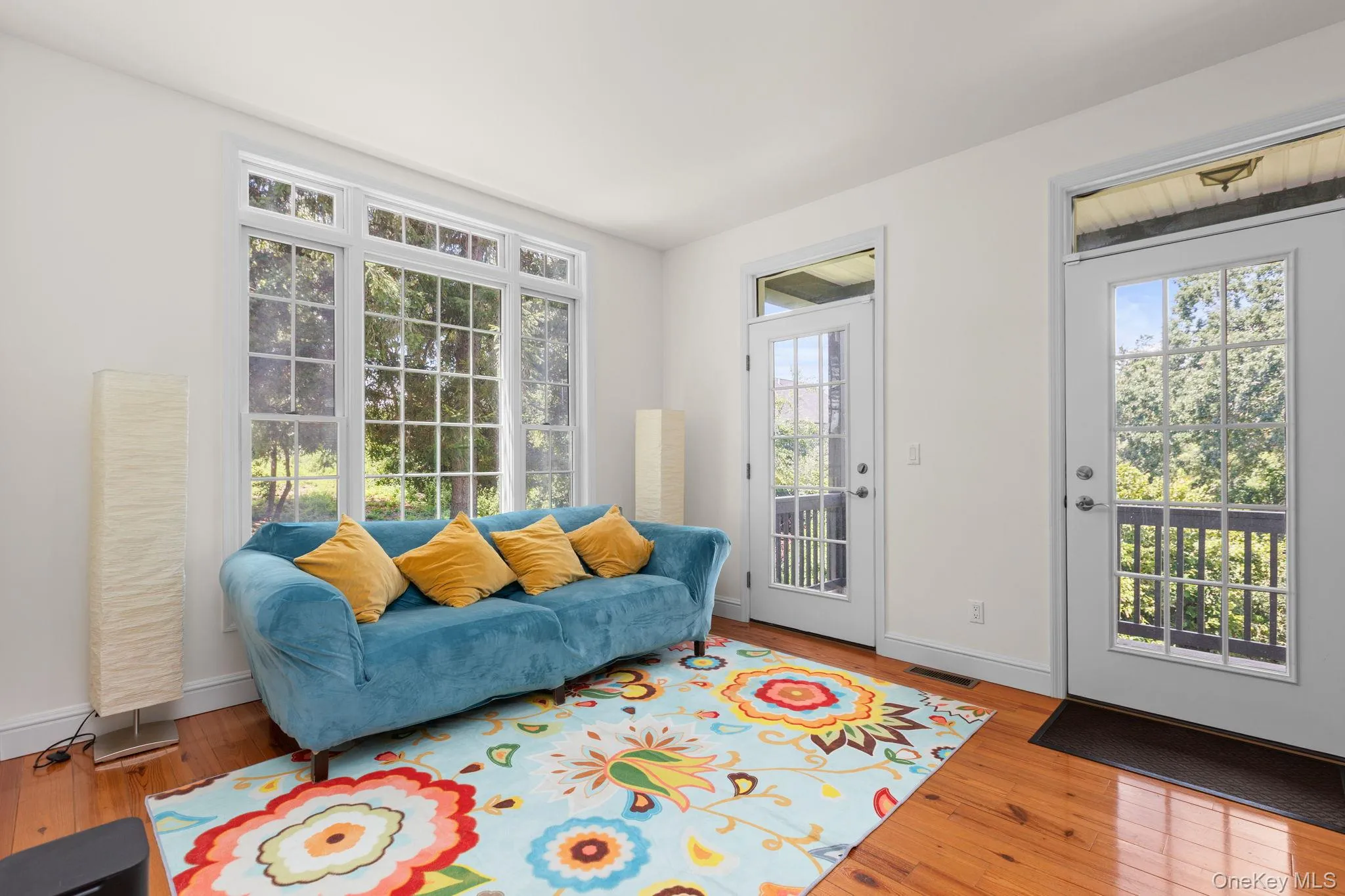 Hardwood floors and door leading to balcony. Hardwood floors and door leading to balcony.