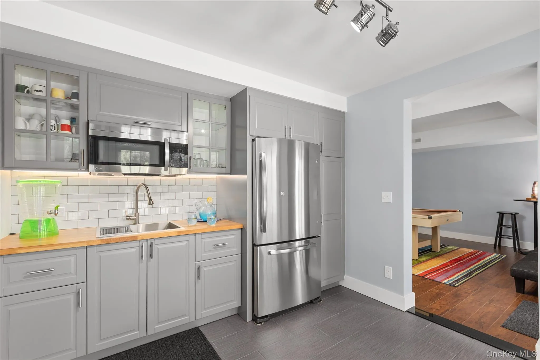 Snack Bar, stainless steel appliances, and contemporary cabinetry Snack Bar, stainless steel appliances, and contemporary cabinetry