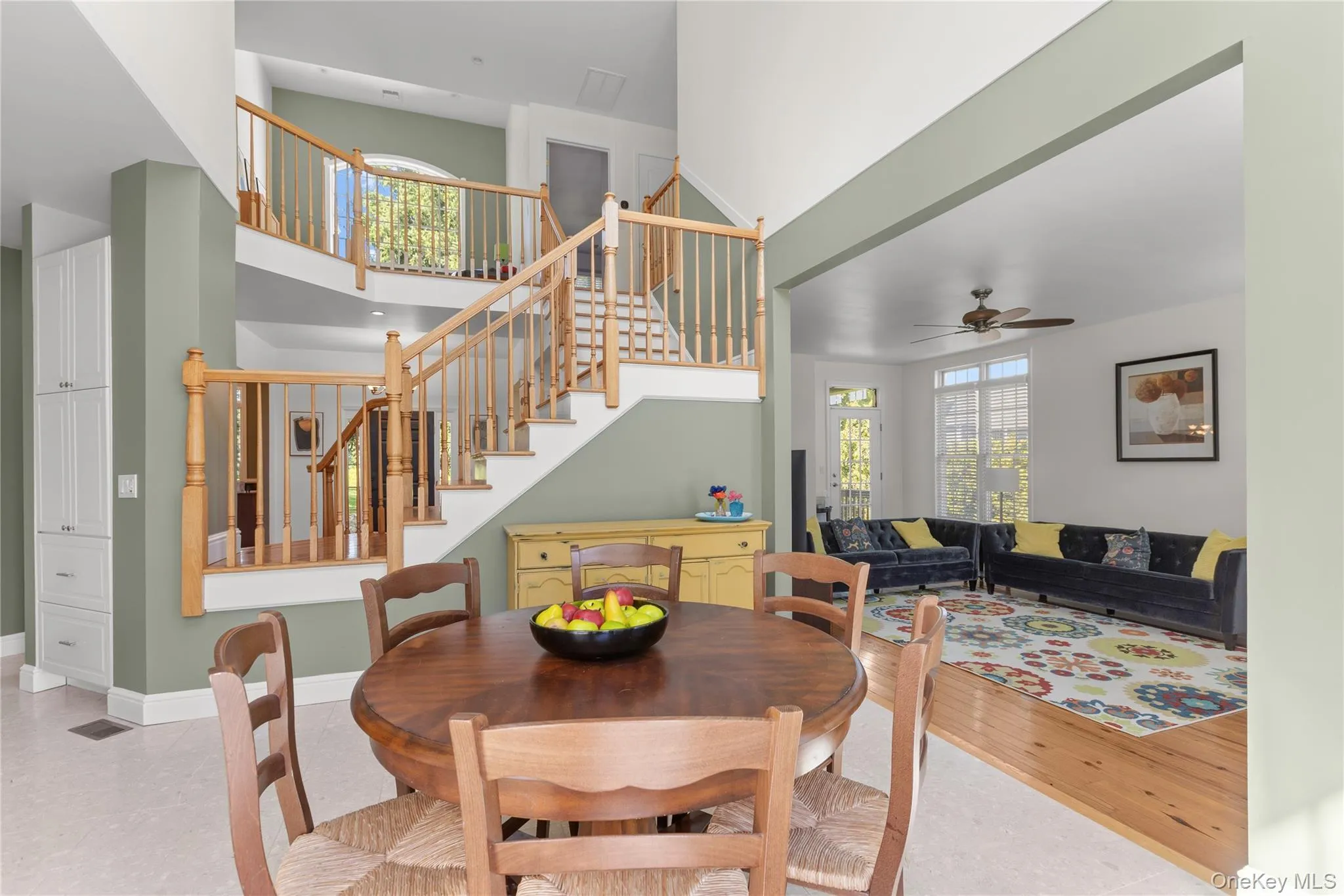 With cream tile flooring view of built in wooden staircase to the second floor With cream tile flooring view of built in wooden staircase to the second floor