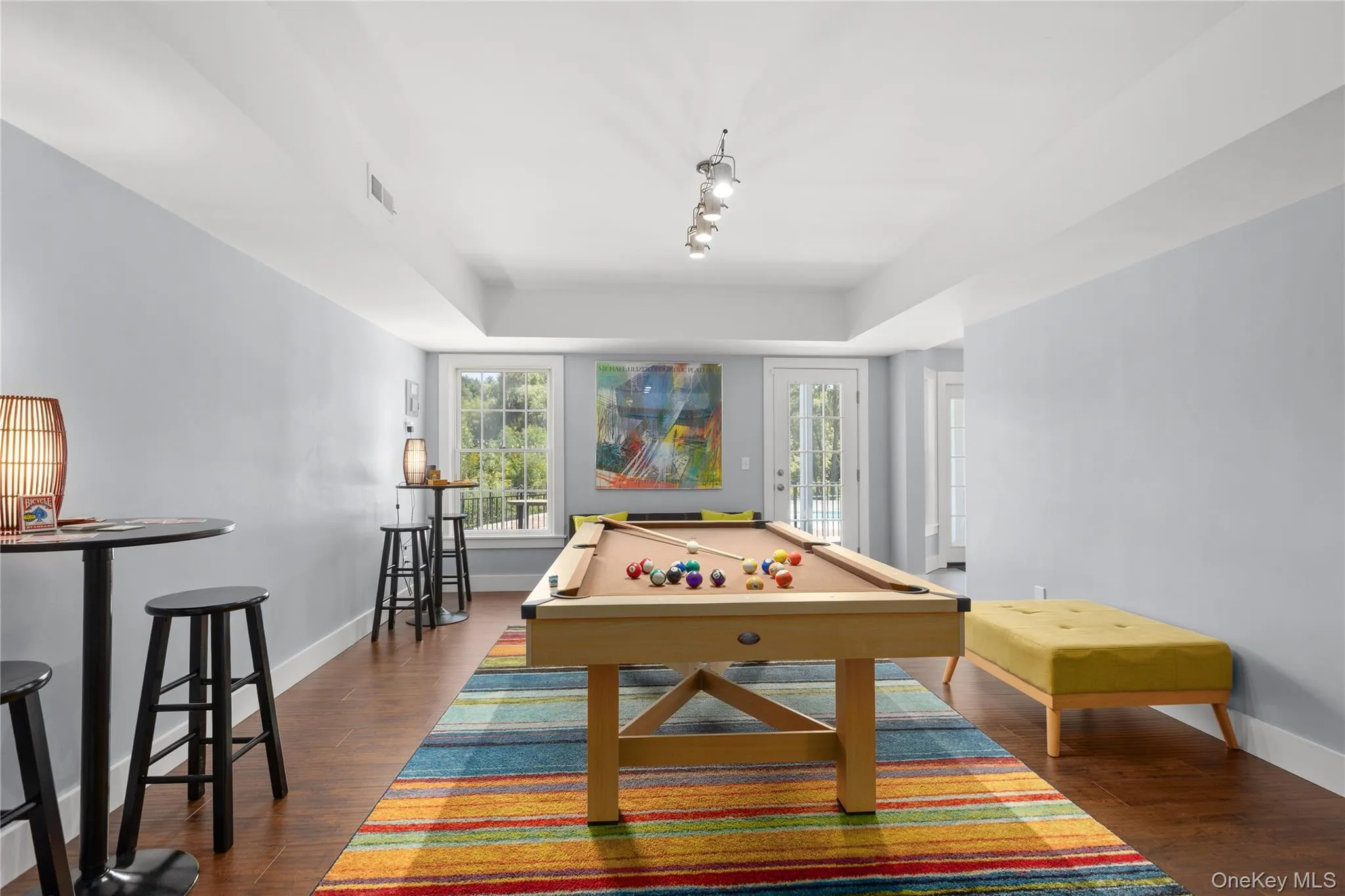 Recreation room featuring a regulation pool table with natural wood frame and felt playing surface, complemented by hardwood flooring throughout Recreation room featuring a regulation pool table with natural wood frame and felt playing surface, complemented by hardwood flooring throughout