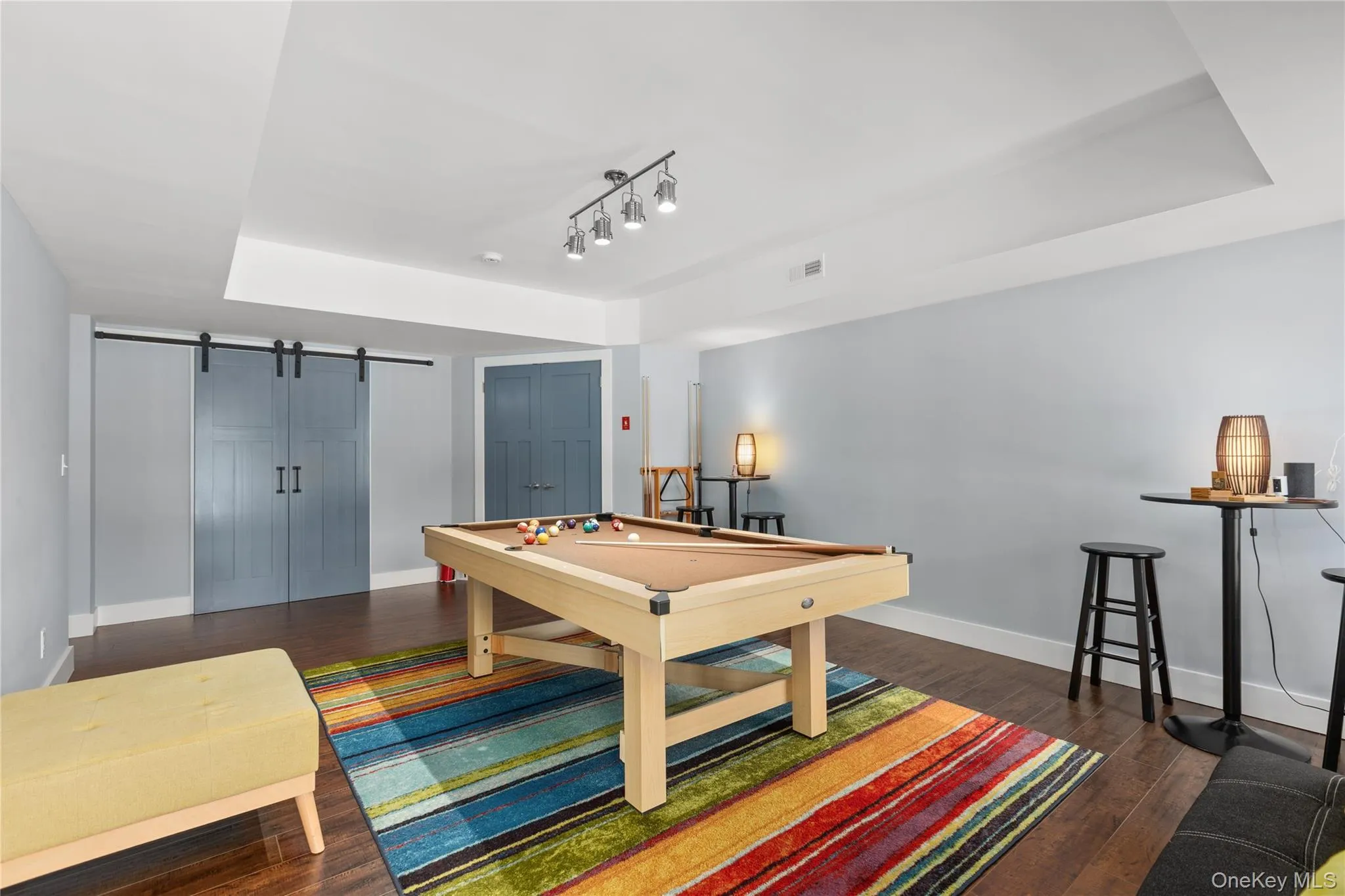 Recreation room featuring a regulation pool table with natural wood frame and felt playing surface, complemented by hardwood flooring throughout Recreation room featuring a regulation pool table with natural wood frame and felt playing surface, complemented by hardwood flooring throughout