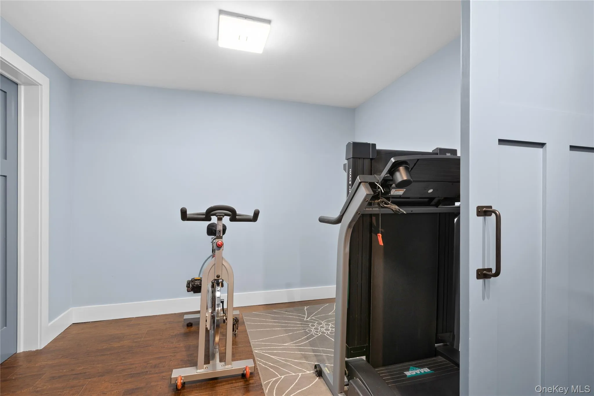 Flexible room with light blue walls and hardwood flooring. Flexible room with light blue walls and hardwood flooring.
