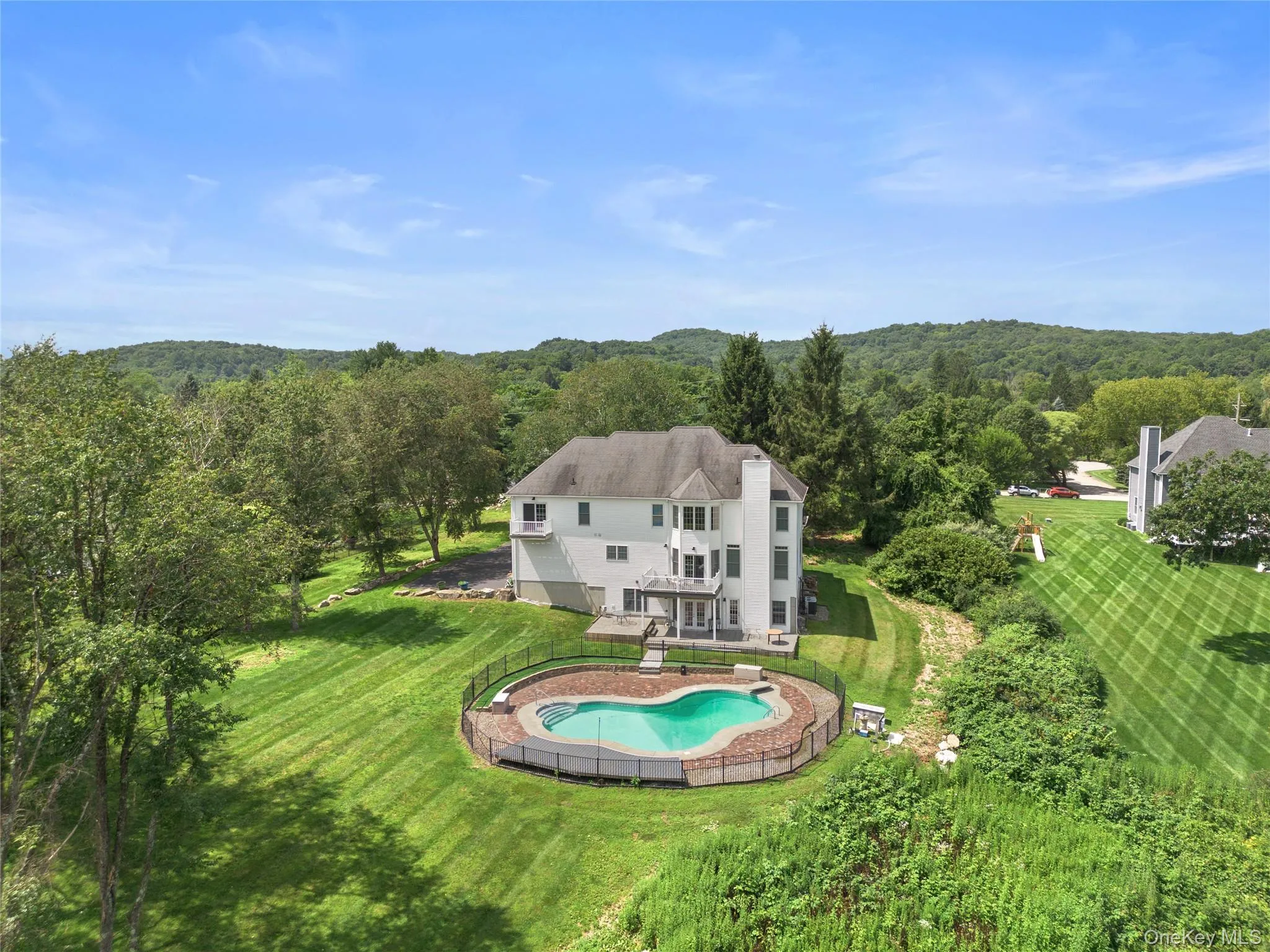 Aerial view of the back of the house showing pool and property Aerial view of the back of the house showing pool and property