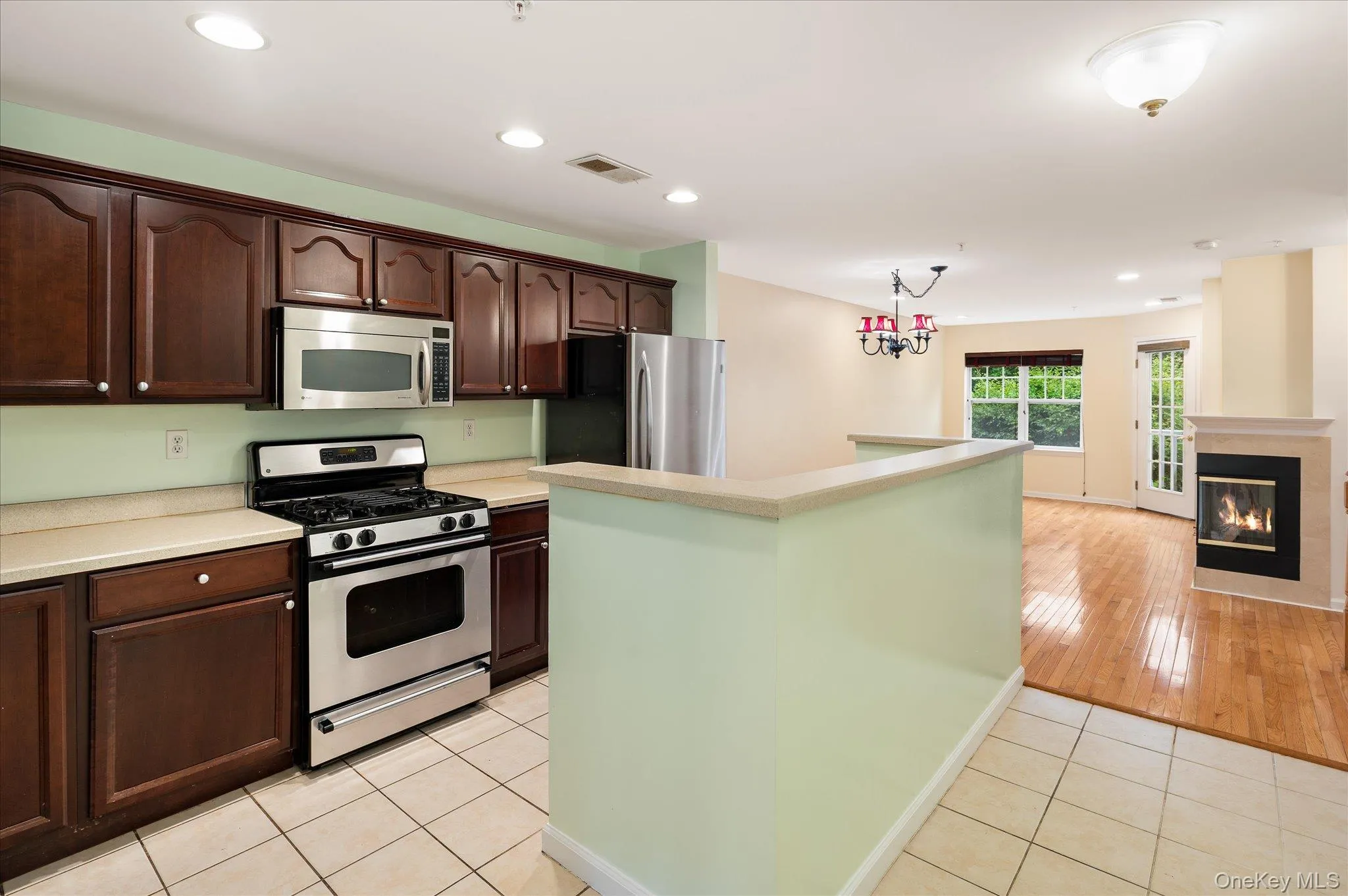 Kitchen features stainless steel appliances and abundant cabinetry and flows seamlessly into the living and dining spaces Kitchen features stainless steel appliances and abundant cabinetry and flows seamlessly into the living and dining spaces