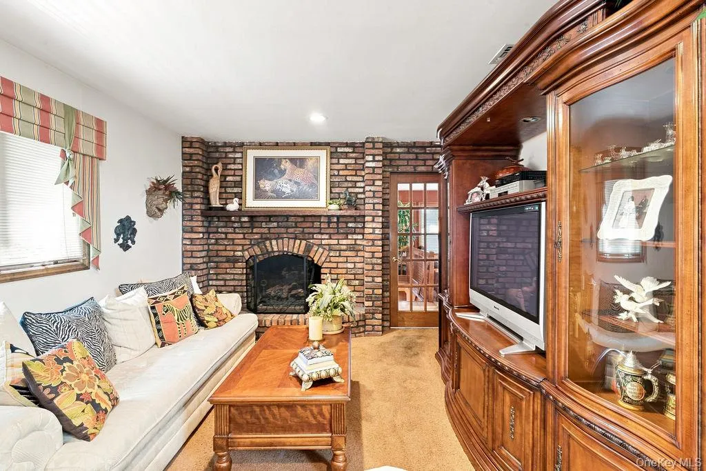 Brick-faced fireplace with a hearth, arched firebox, and mantle Brick-faced fireplace with a hearth, arched firebox, and mantle