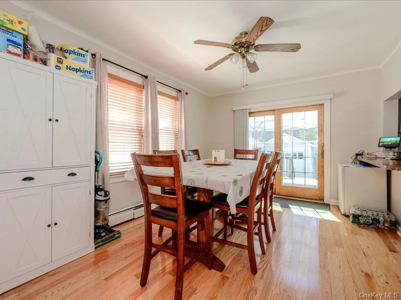 Dining area with hardwood flooring, a ceiling fan, and French doors providing exterior access Dining area with hardwood flooring, a ceiling fan, and French doors providing exterior access