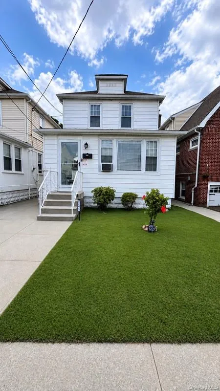 White siding exterior with a dark roof and a front dormer White siding exterior with a dark roof and a front dormer