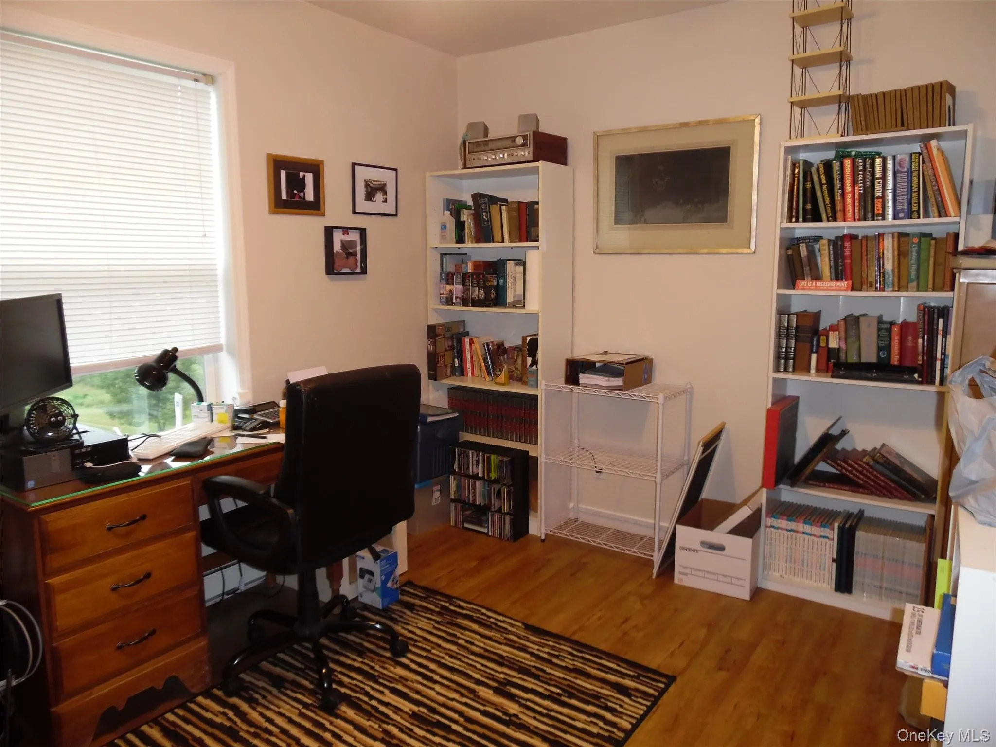 Interior office featuring wood-finish flooring and light-toned walls Interior office featuring wood-finish flooring and light-toned walls