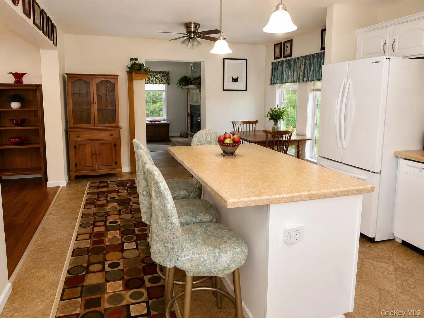 Kitchen featuring a functional island, white cabinetry, and recessed lighting Kitchen featuring a functional island, white cabinetry, and recessed lighting