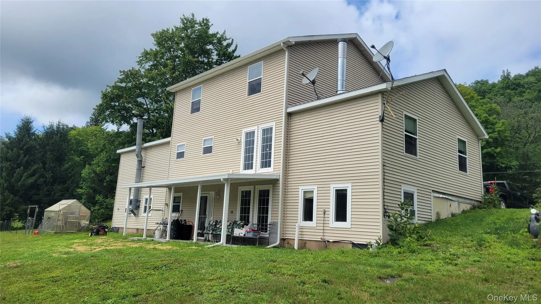 Back of Two-story residence featuring light-toned horizontal siding Back of Two-story residence featuring light-toned horizontal siding