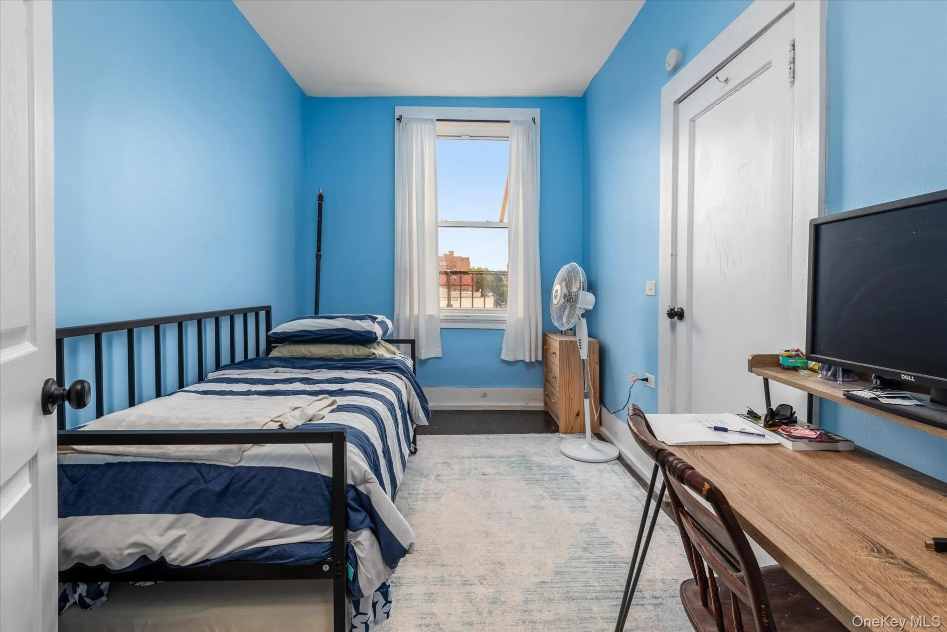 Room featuring light blue painted walls, white trim, and a window with white blinds Room featuring light blue painted walls, white trim, and a window with white blinds