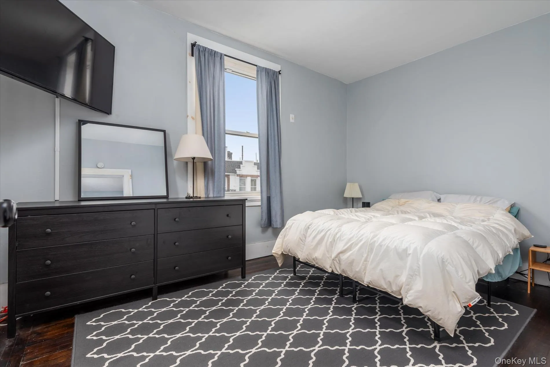 Master Bedroom. Room featuring dark wood-finish flooring and light blue walls Master Bedroom. Room featuring dark wood-finish flooring and light blue walls