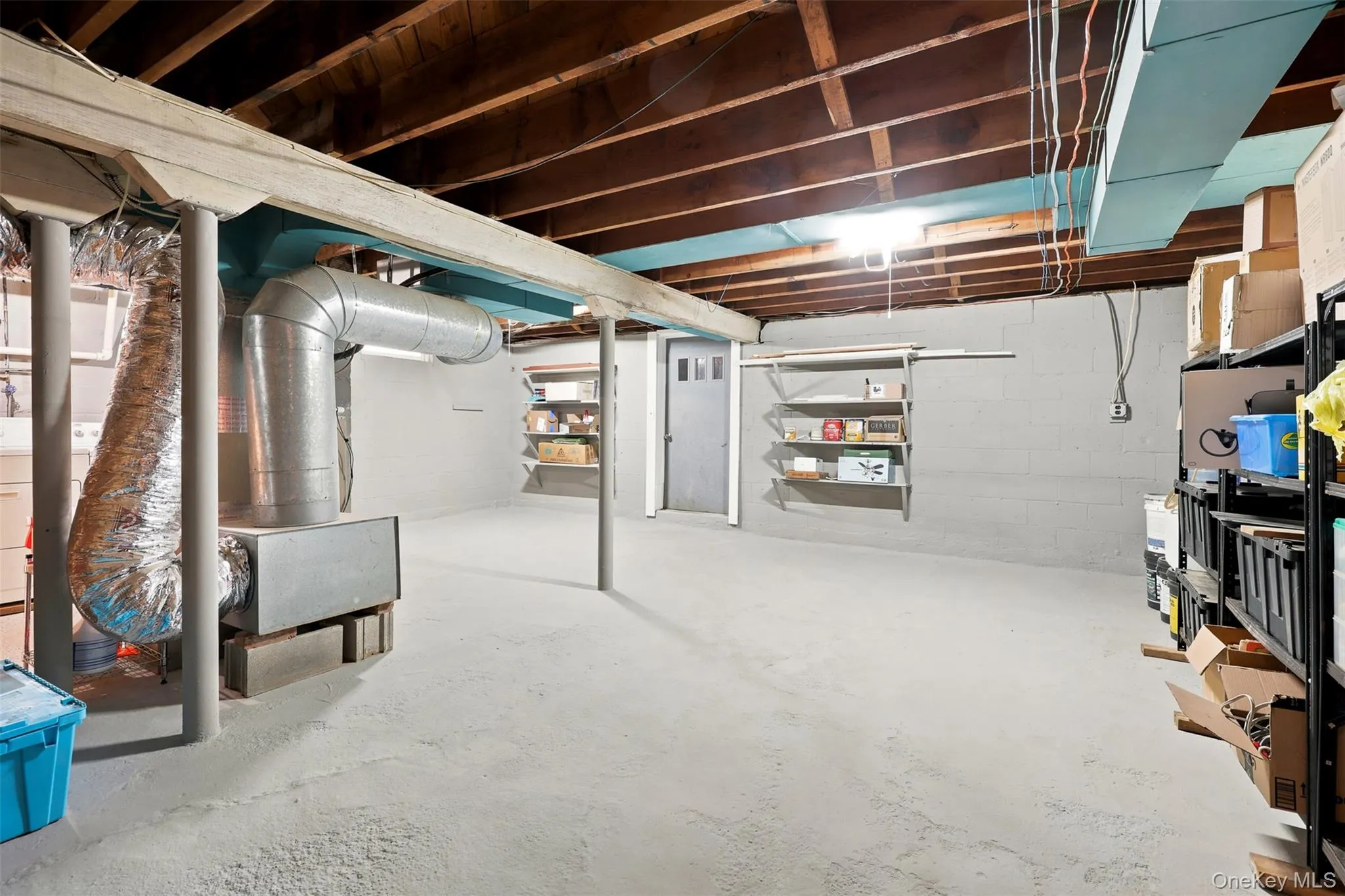Unfinished basement featuring exposed wood ceiling joists and concrete flooring Unfinished basement featuring exposed wood ceiling joists and concrete flooring