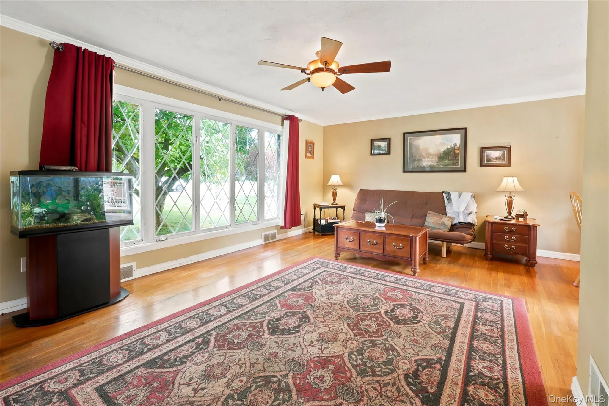 Hardwood flooring throughout the room, complemented by a wide window featuring diamond-patterned grilles Hardwood flooring throughout the room, complemented by a wide window featuring diamond-patterned grilles