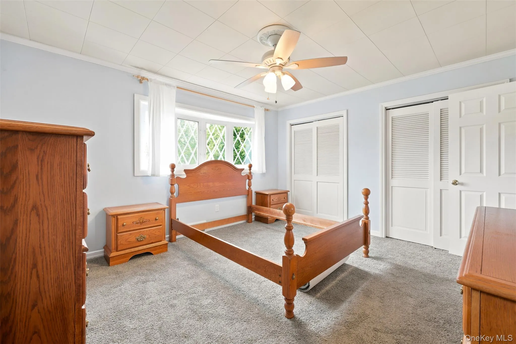 Carpeted room with a ceiling fan light fixture Carpeted room with a ceiling fan light fixture