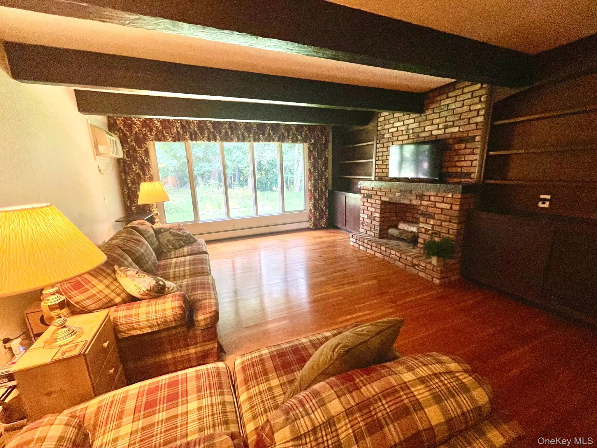 Large Cozy Family Room with Brick Fireplace, H/W floors, Exposed beams with large windows letting light pour in Large Cozy Family Room with Brick Fireplace, H/W floors, Exposed beams with large windows letting light pour in