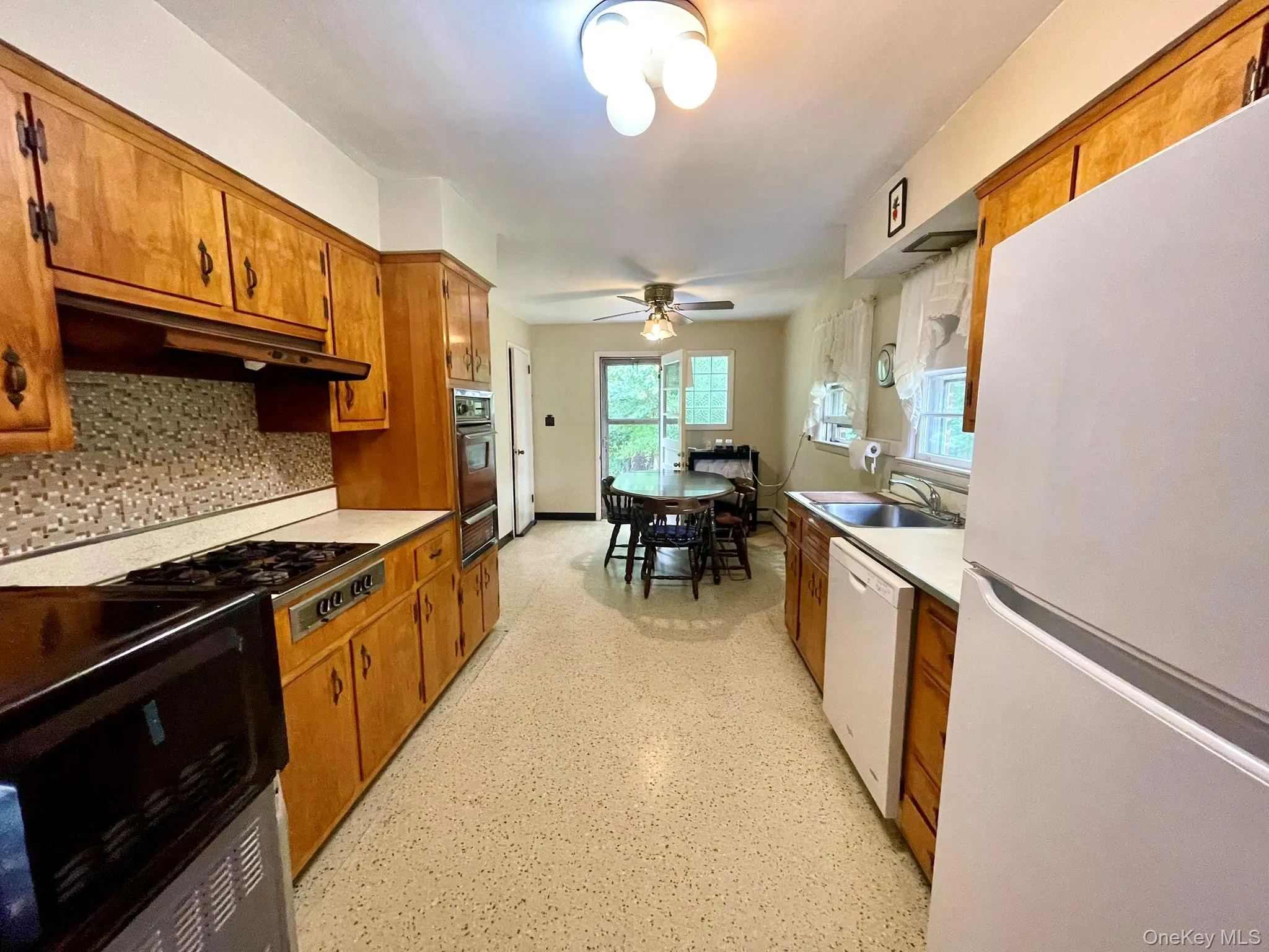 Eat in Kitchen with plenty of cabinets and counters with door leading to backyard Eat in Kitchen with plenty of cabinets and counters with door leading to backyard