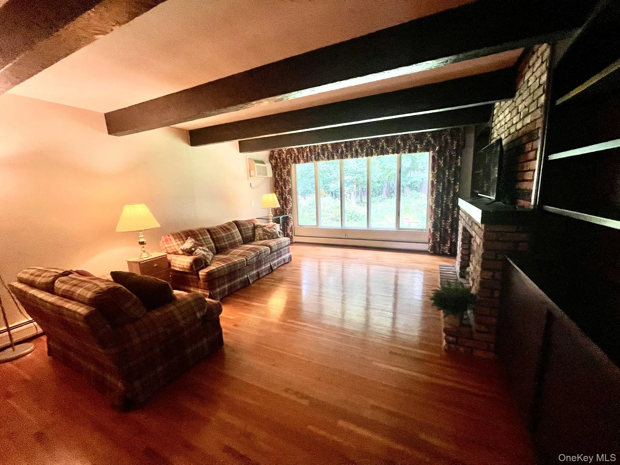 Large Cozy Family Room with Brick Fireplace, H/W floors, Exposed beams with large windows letting light pour in Large Cozy Family Room with Brick Fireplace, H/W floors, Exposed beams with large windows letting light pour in