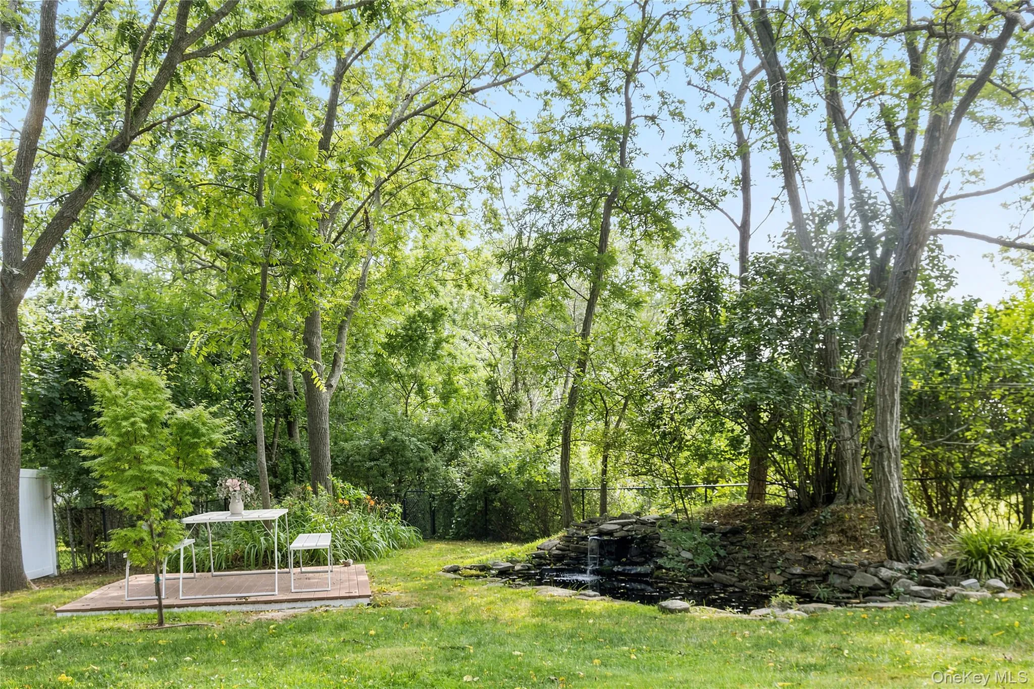 Spacious back yard with picnic area and koi pond with small waterfall Spacious back yard with picnic area and koi pond with small waterfall