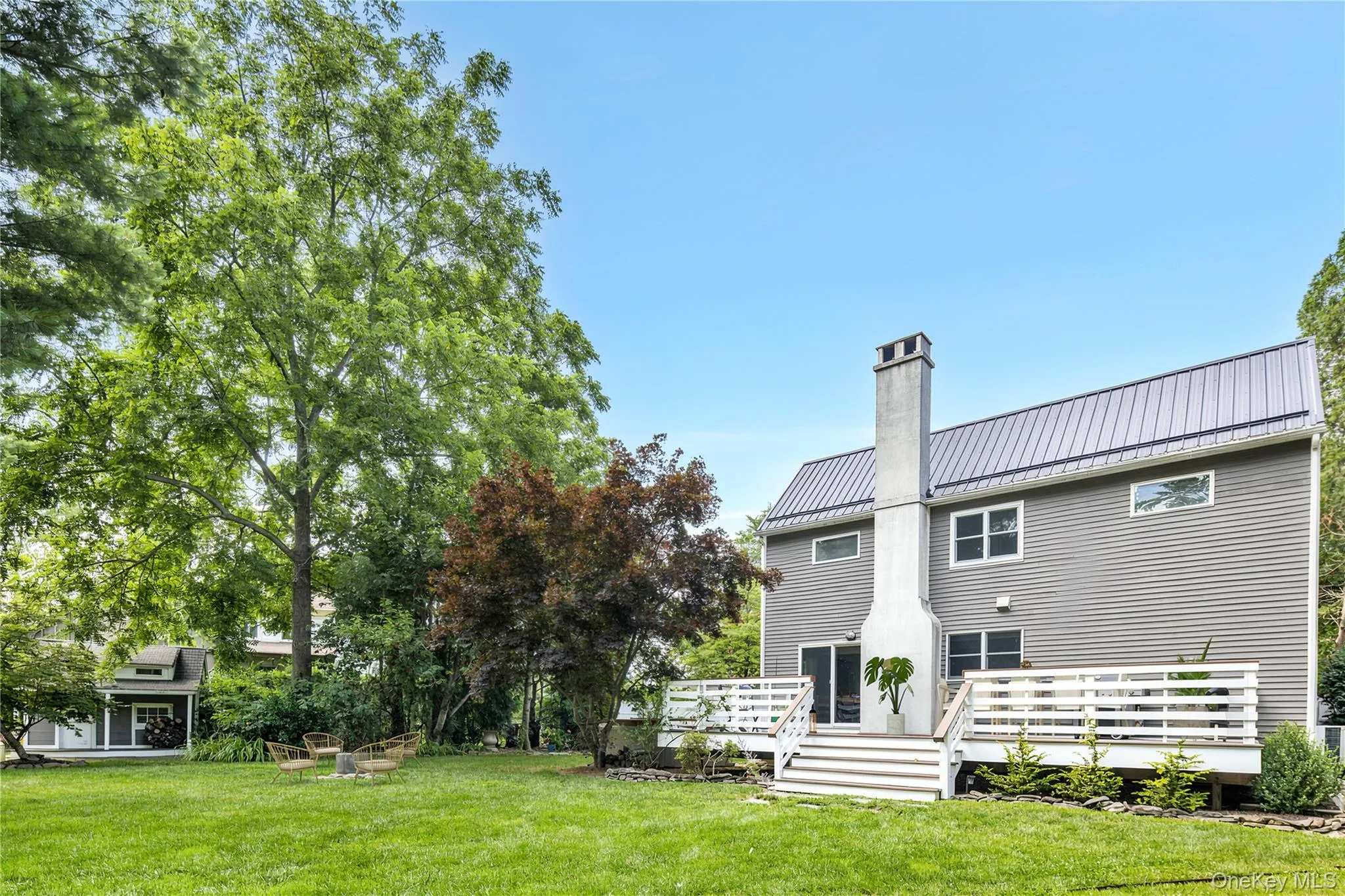 Spacious back yard showing deck and fire pit area with plenty of room for a pool Spacious back yard showing deck and fire pit area with plenty of room for a pool