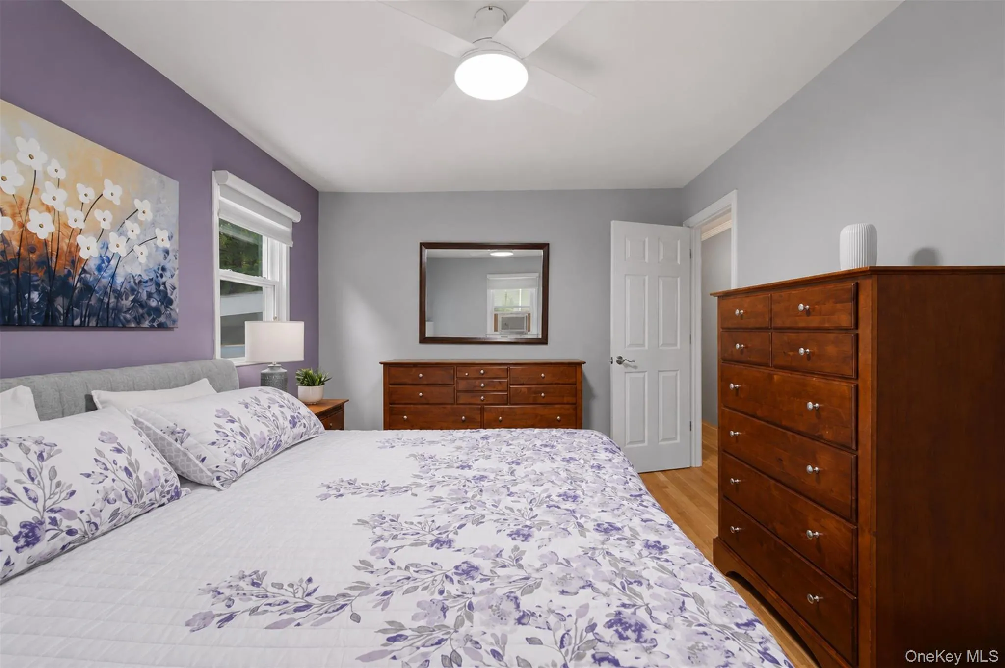 Bedroom featuring wood-finish flooring and a ceiling fan Bedroom featuring wood-finish flooring and a ceiling fan