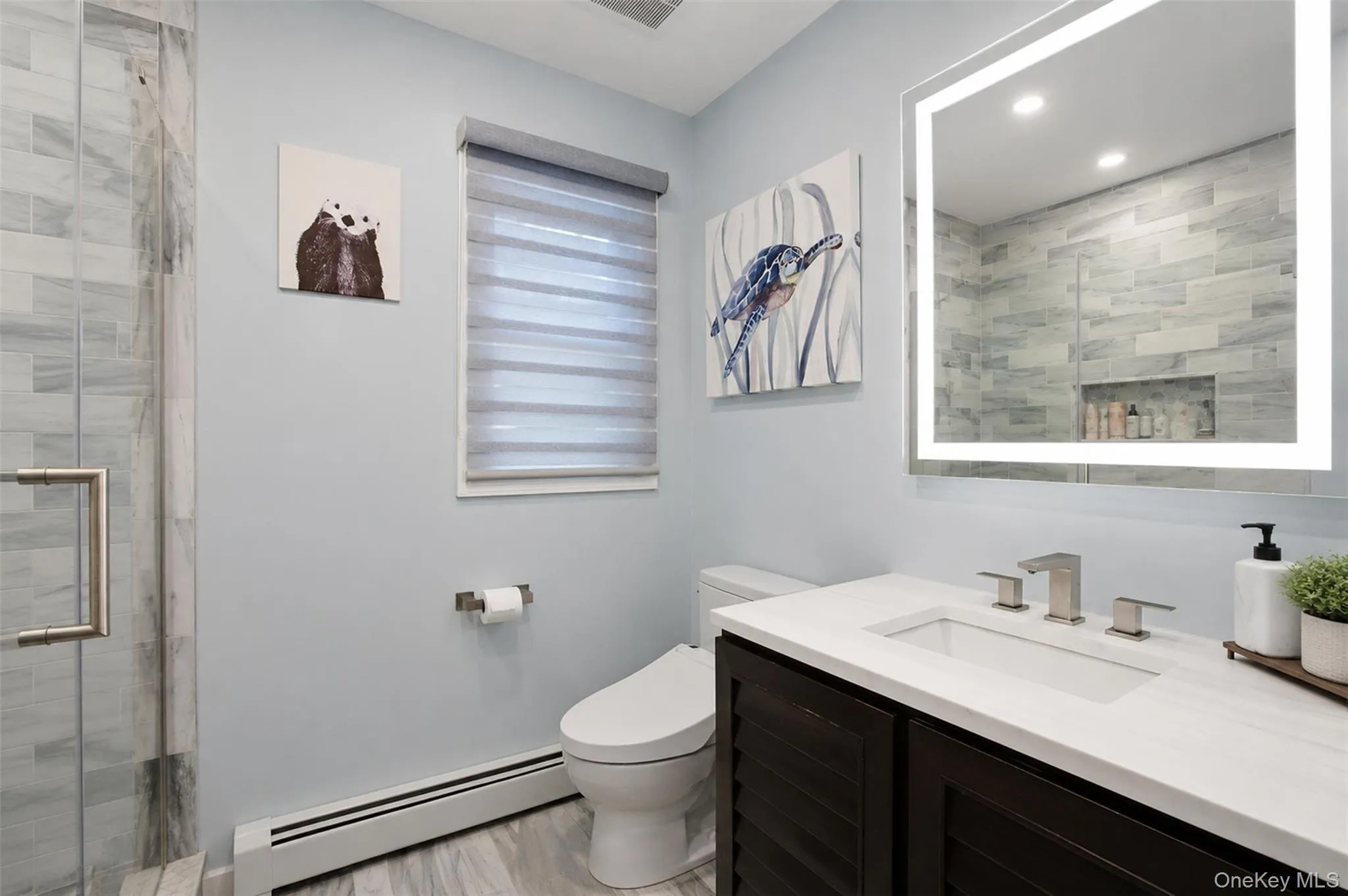 Contemporary bathroom featuring a dark wood-finish vanity with a white countertop and rectangular undermount sink Contemporary bathroom featuring a dark wood-finish vanity with a white countertop and rectangular undermount sink