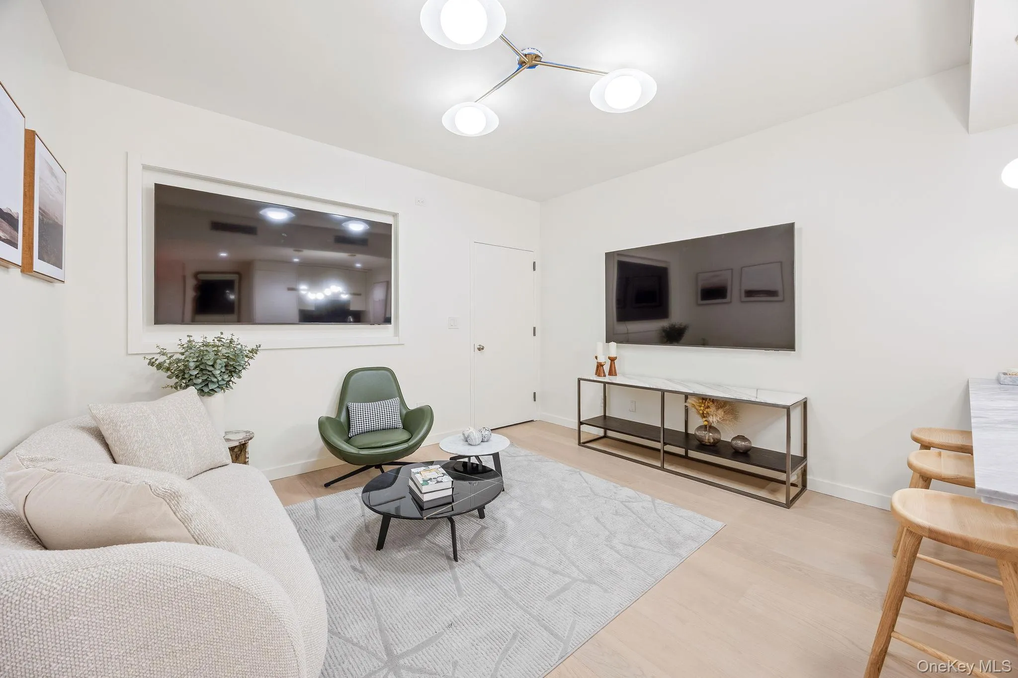 Living area with wood finished floors and baseboards Living area with wood finished floors and baseboards