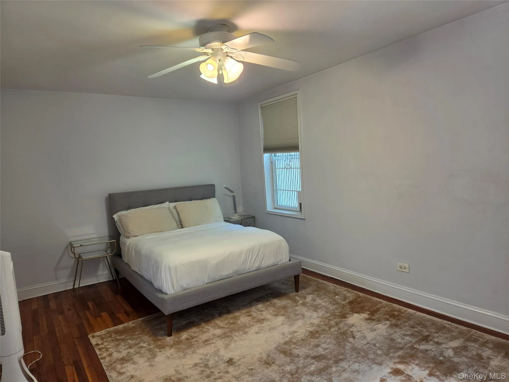Windowed bedroom with fan. Windowed bedroom with fan.