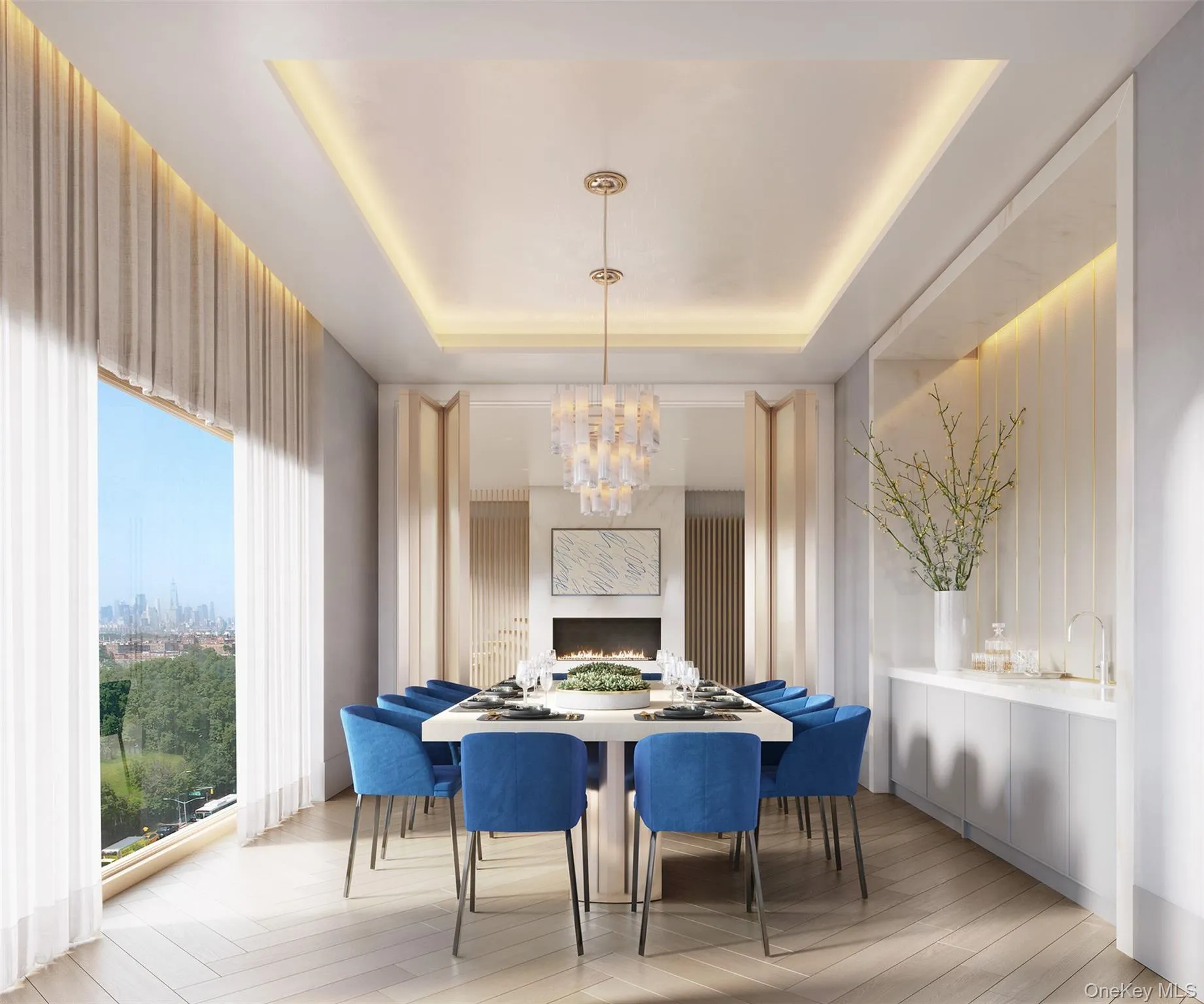 Dining space featuring a chandelier, a warm lit fireplace, a raised ceiling, and light wood-style floors Dining space featuring a chandelier, a warm lit fireplace, a raised ceiling, and light wood-style floors