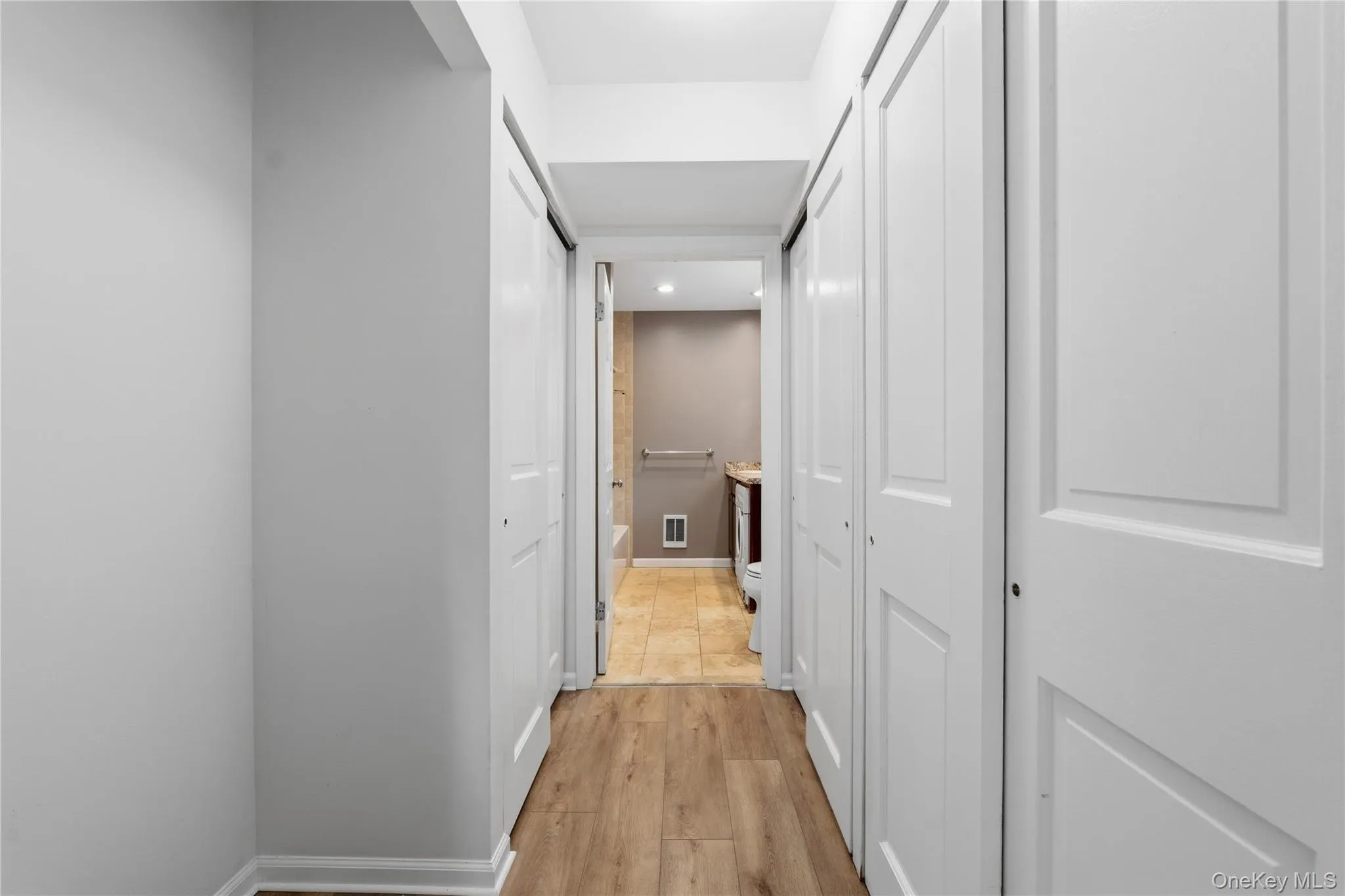 Hallway with several large closets for storage. Hallway with several large closets for storage.