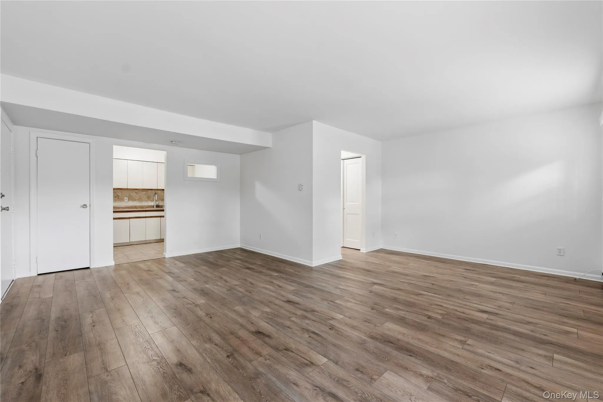 Kitchen on left and hallway with closets to bathroom on right. Kitchen on left and hallway with closets to bathroom on right.